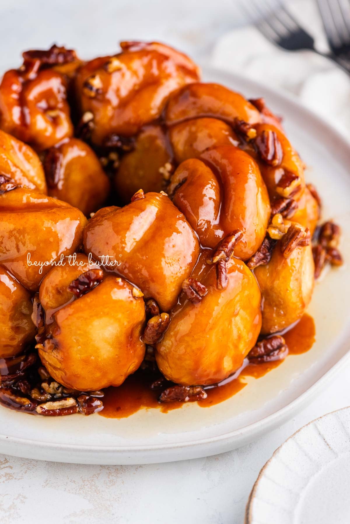 Monkey bread breakfast treat on a white dessert plate and white background | © Luyiz®