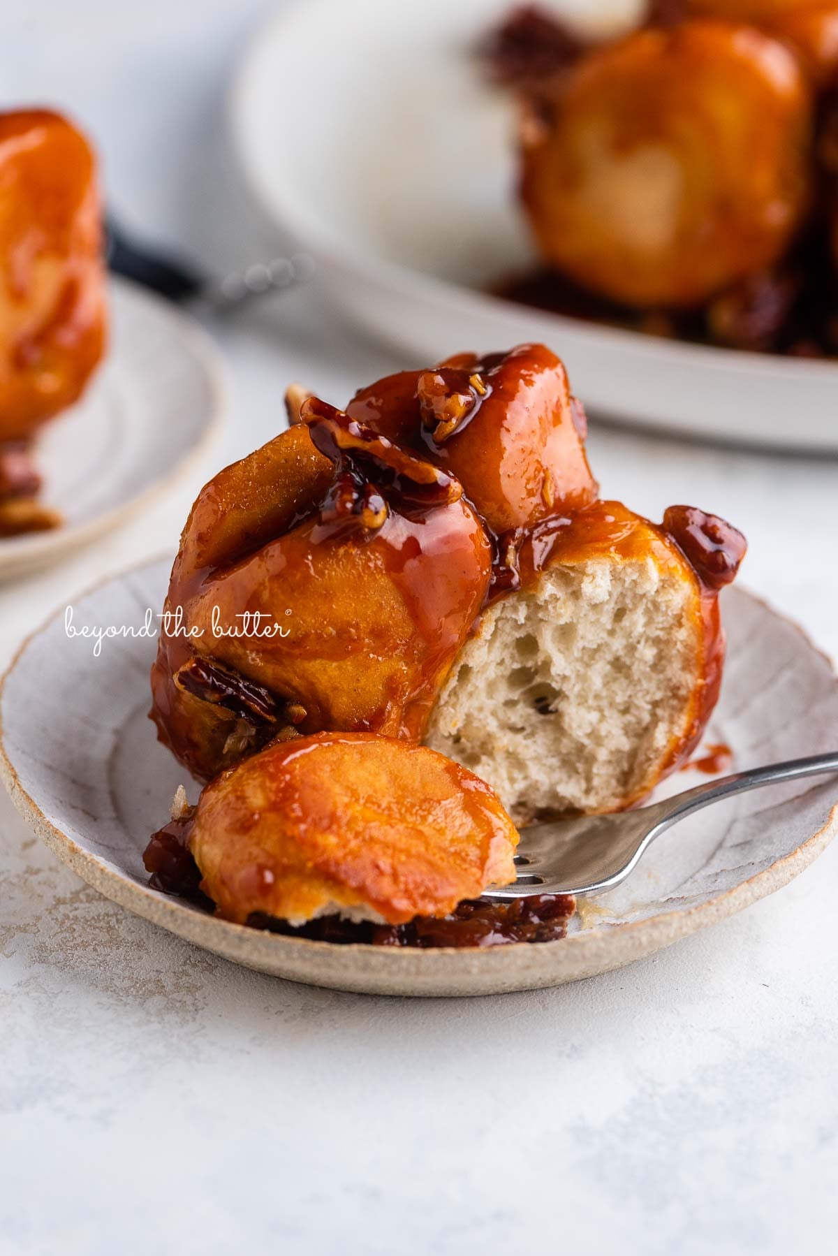 Individual plate of partially eaten butterscotch rolls on a white background | © Luyiz®