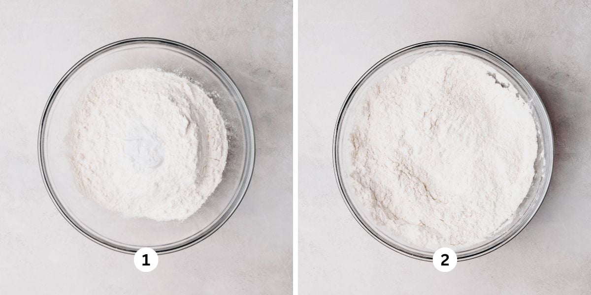 Whisking coffee cake dry ingredients together in a glass bowl on a white background.