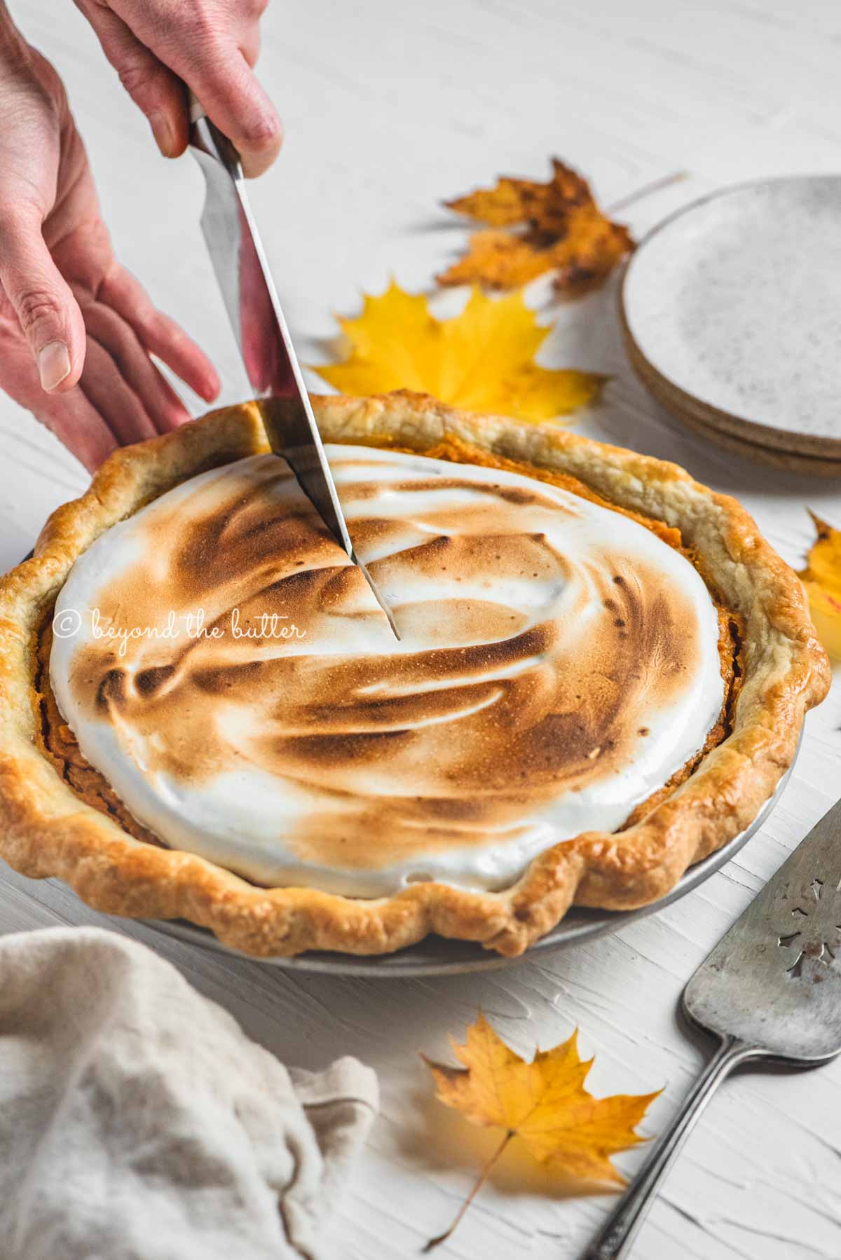 Cutting into the brown sugar sweet potato pie with pie server, plates, and napkin around it | | All Images © Luyiz®