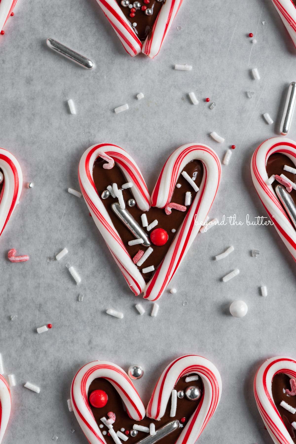 Fun candy cane hearts on parchment paper | © Luyiz®