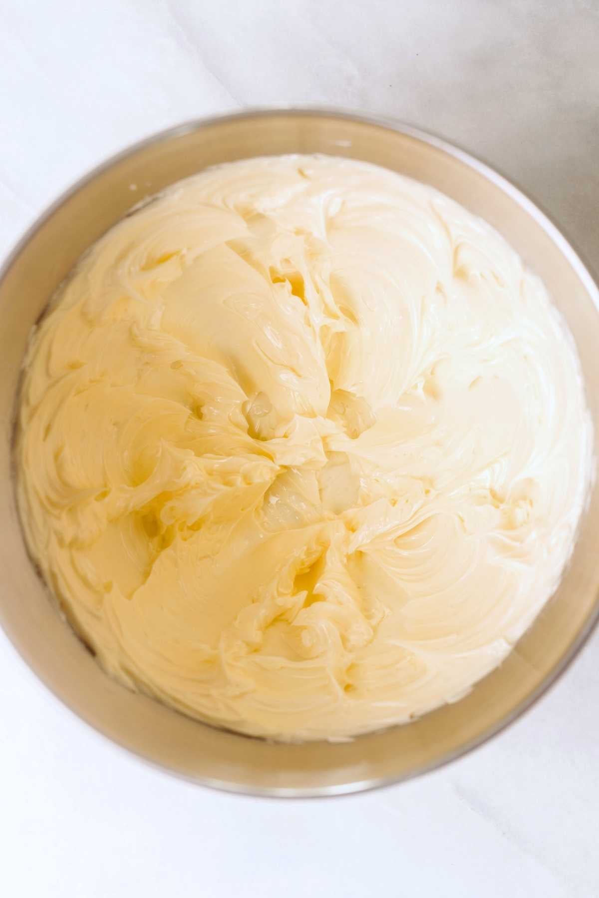 Unsalted butter blended until smooth in a stainless steel mixing bowl.