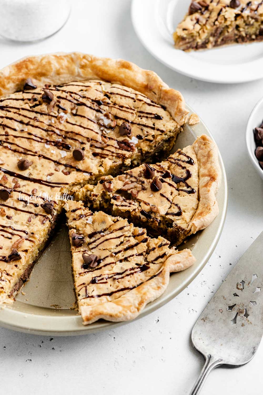 Overhead angled image of chocolate chip pie with 2 slices cut | All Images © Luyiz™