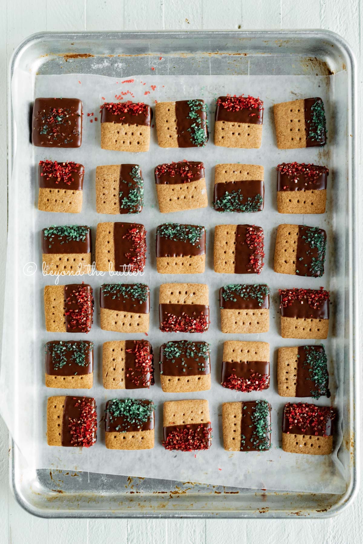 Cookie sheet with rows of Chocolate Dipped Graham Cracker Sqaures | © Luyiz®