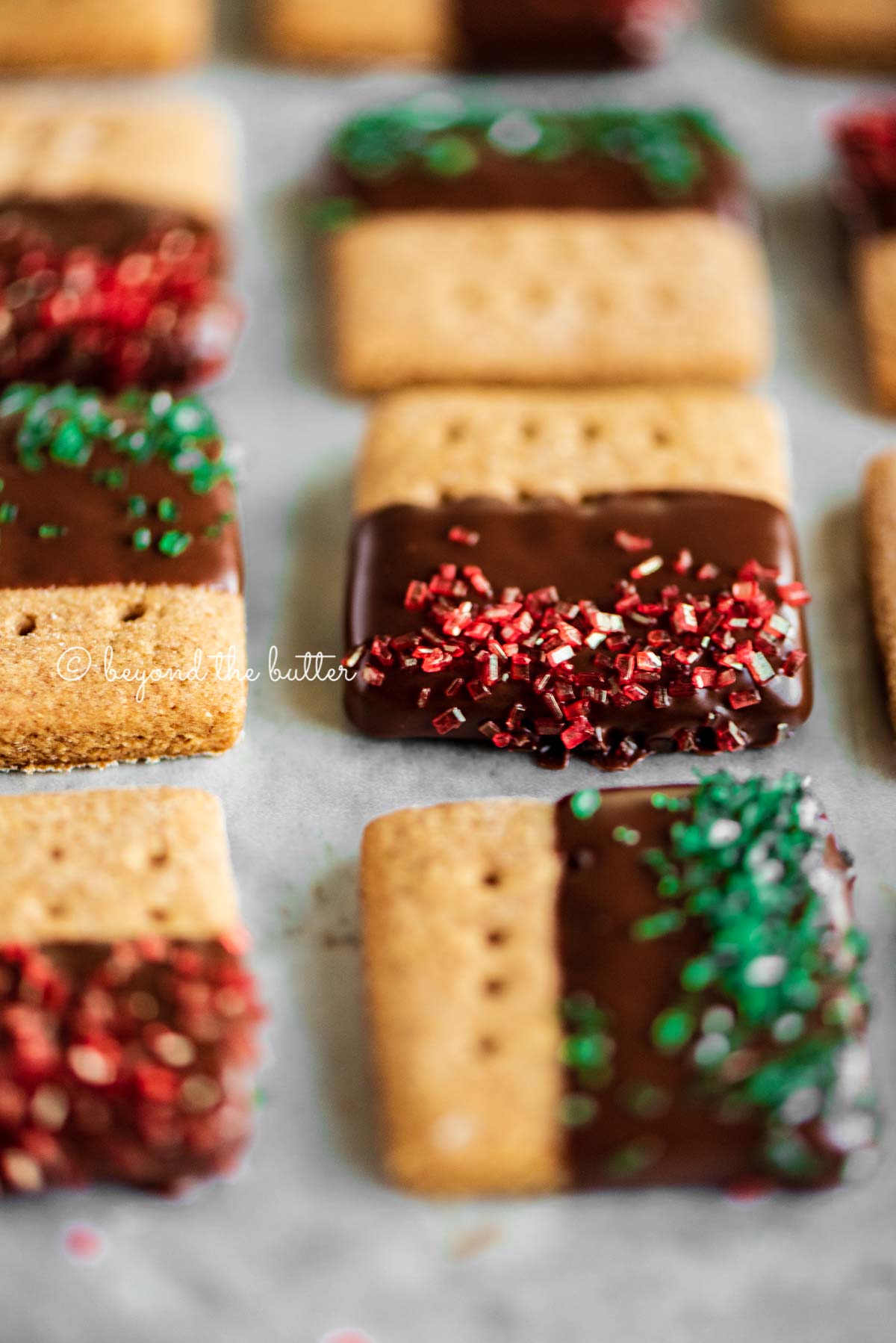 Close up image of Chocolate Dipped Graham Cracker Sqaures on a cookie sheet | © Luyiz®