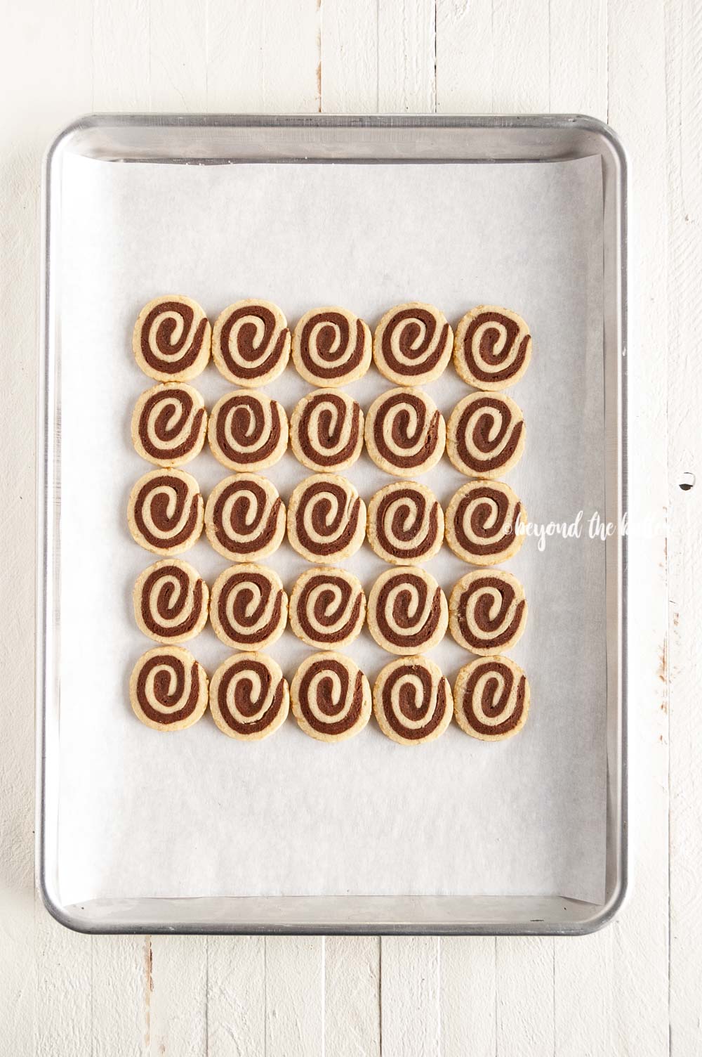 Overhead image of Chocolate Pinwheel Cookies in rows on a baking sheet | All images © Luyiz™