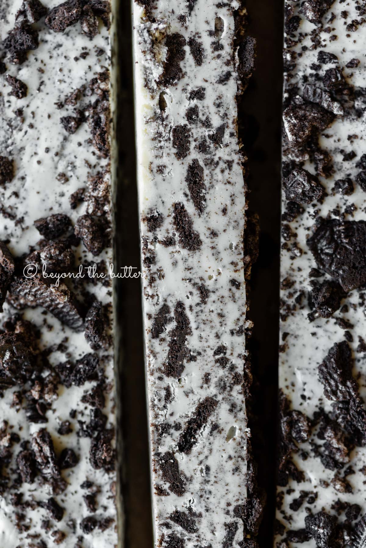 Bars of cookies and cream fudge on brown parchment paper | All Images © Luyiz®