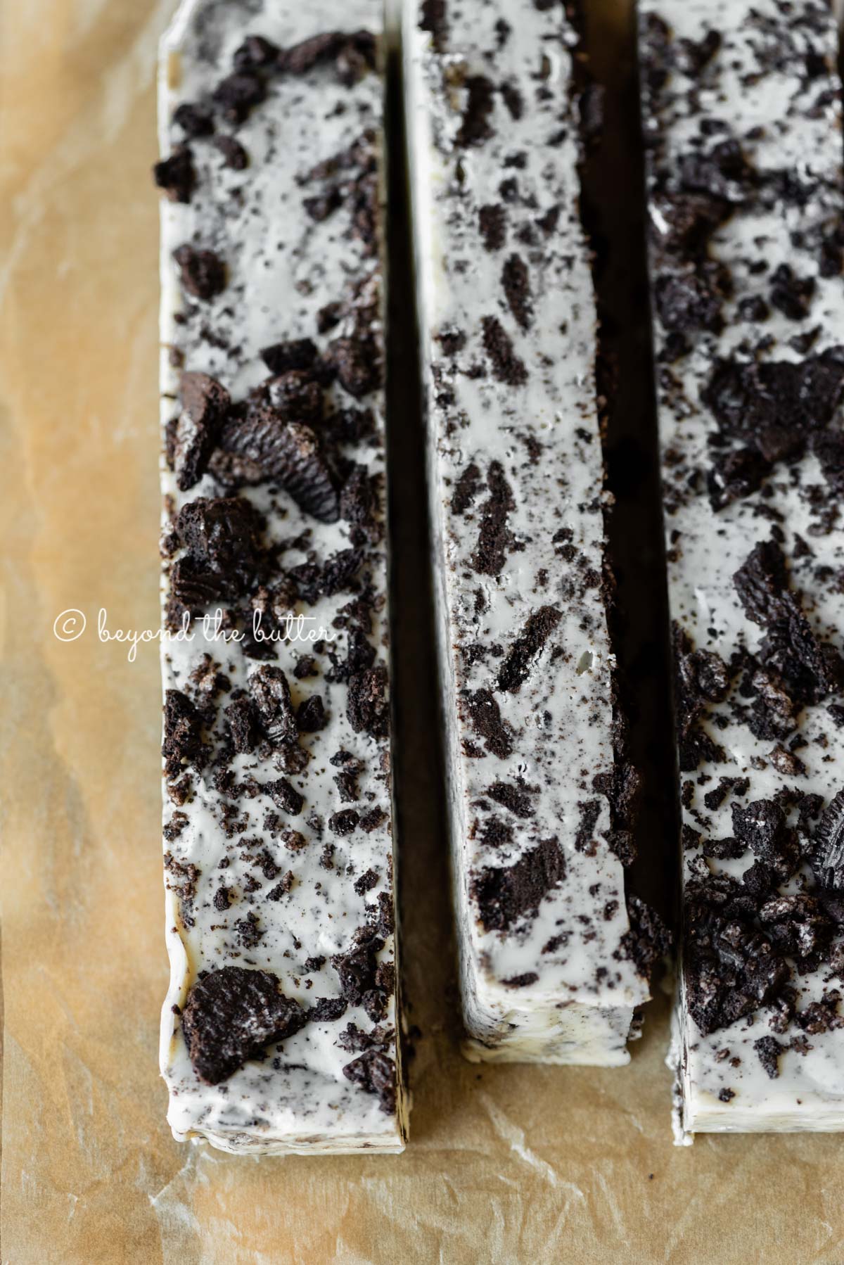 Bars of cookies and cream fudge on brown parchment paper | All Images © Luyiz®