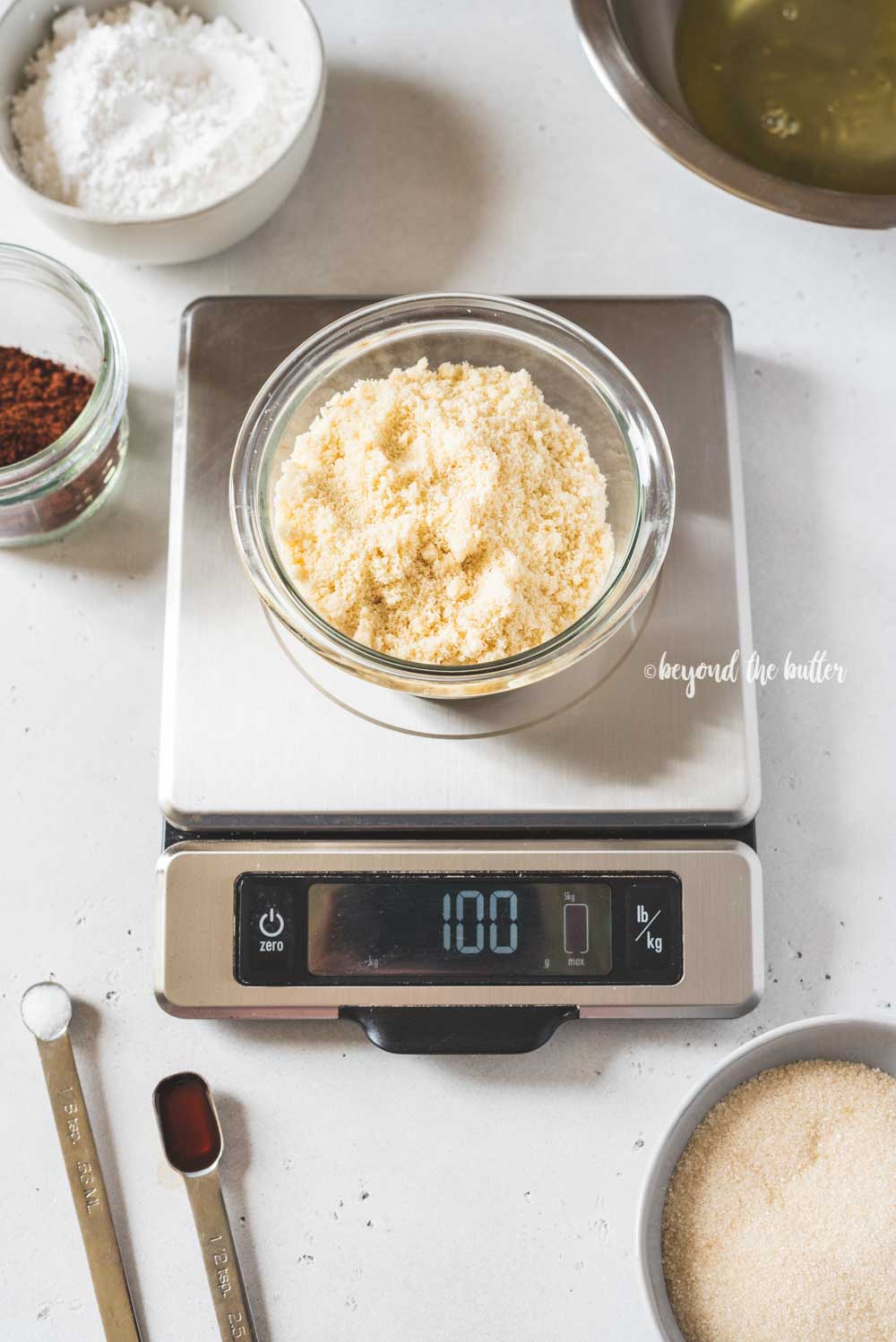 Angled image of dark chocolate macaron ingredients being weighed | All Images © Luyiz™