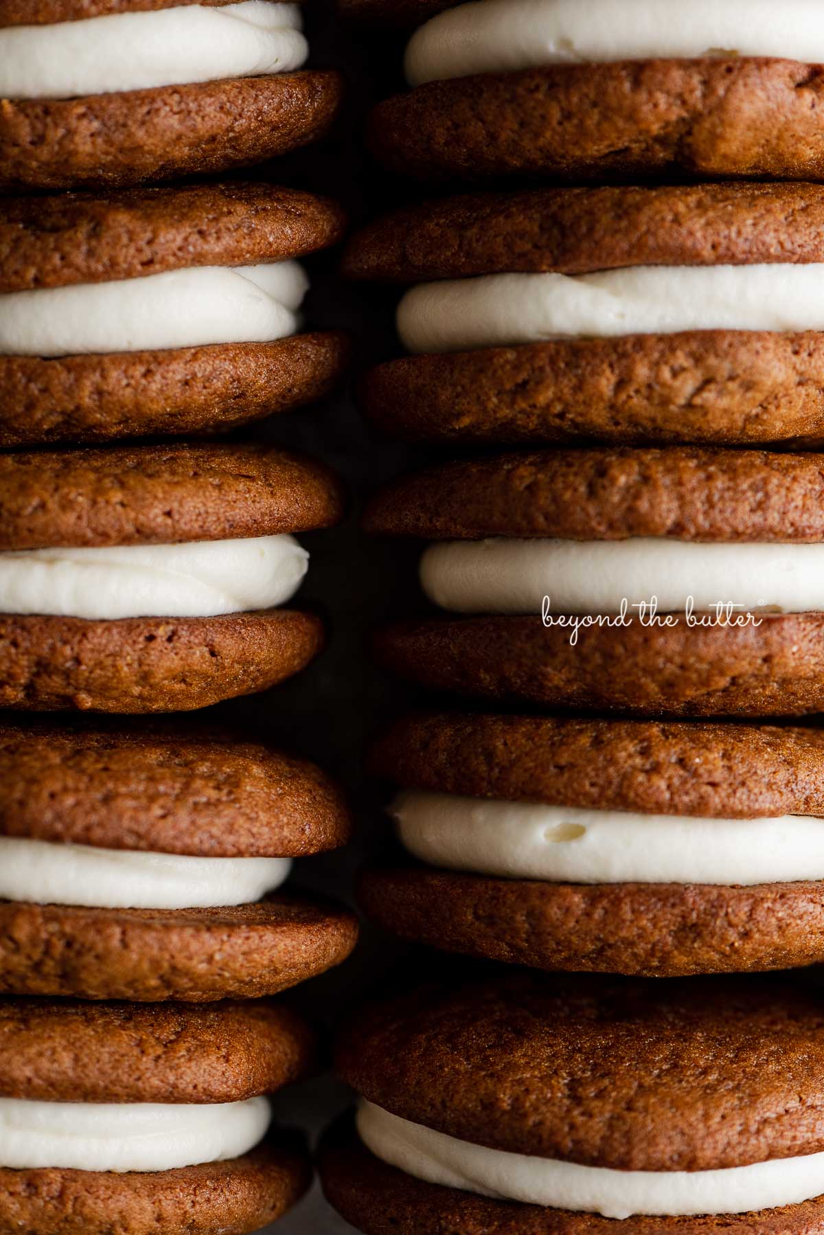 Stacked homemade gingerbread whoopie pies filled with cream cheese frosting | © Luyiz®