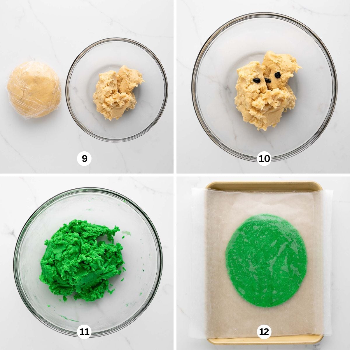 Dividing cookie dough and coloring one third of it green in a glass mixing bowl then rolling it out flat between two sheets of wax paper on a white marbled background.