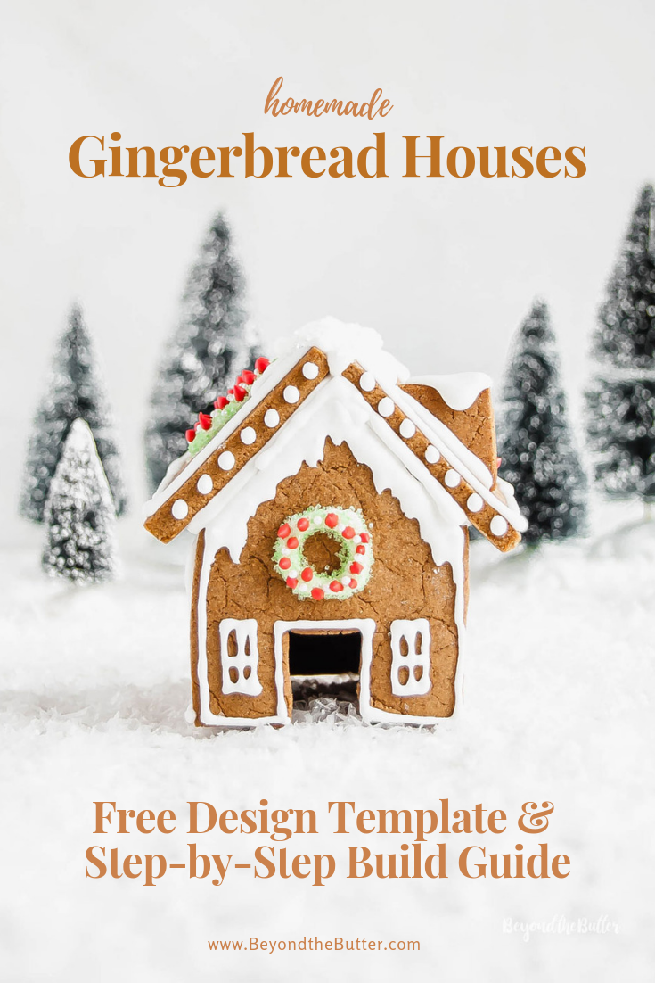 Homemade Gingerbread Houses - front view of gingerbread house with a wreath above the door and trees in the background