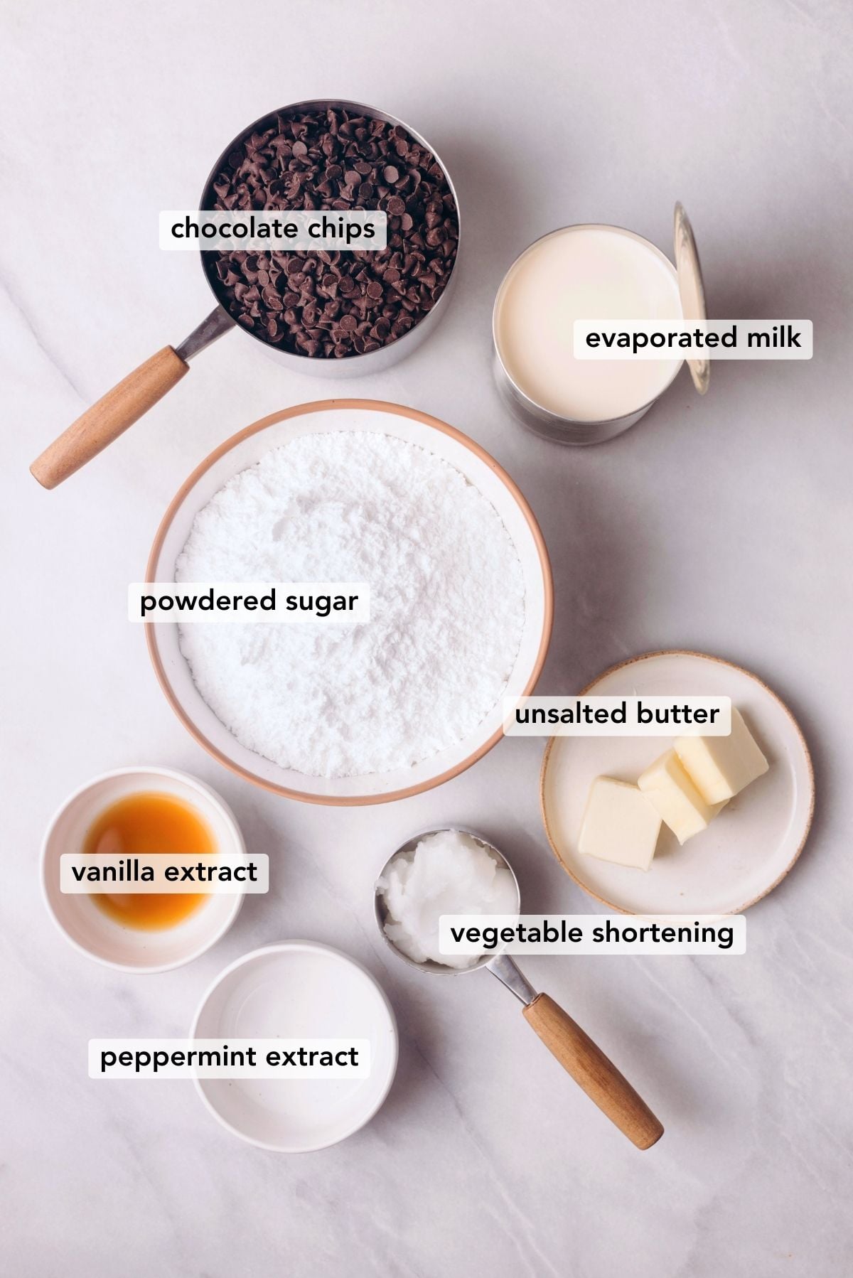 Ingredients needed to make homemade peppermint patties on white marbled background.