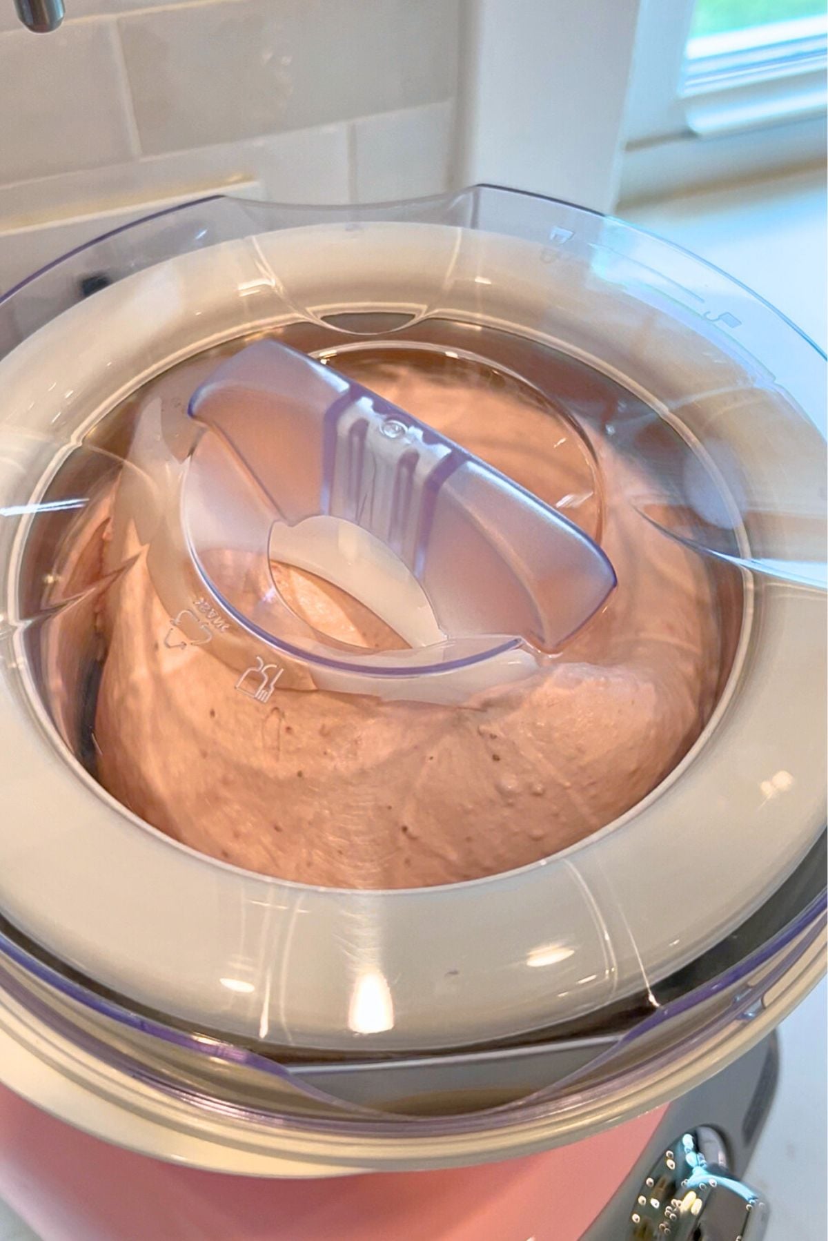 Churning the strawberry ice cream base in the Cloudy Pink Ankarsrum Assistent Original Mixer and ice cream maker attachment.