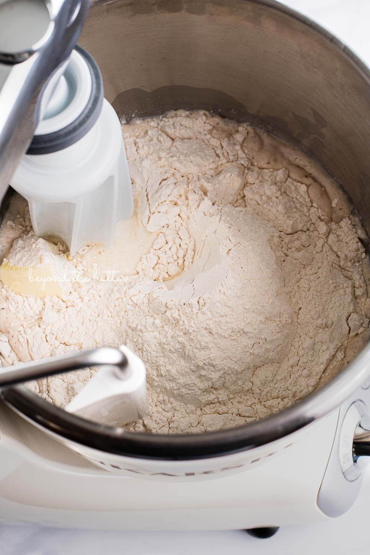 Ankarsrum original mixer filled with ingredients to make homemade honey butter dinner rolls | © Luyiz®
