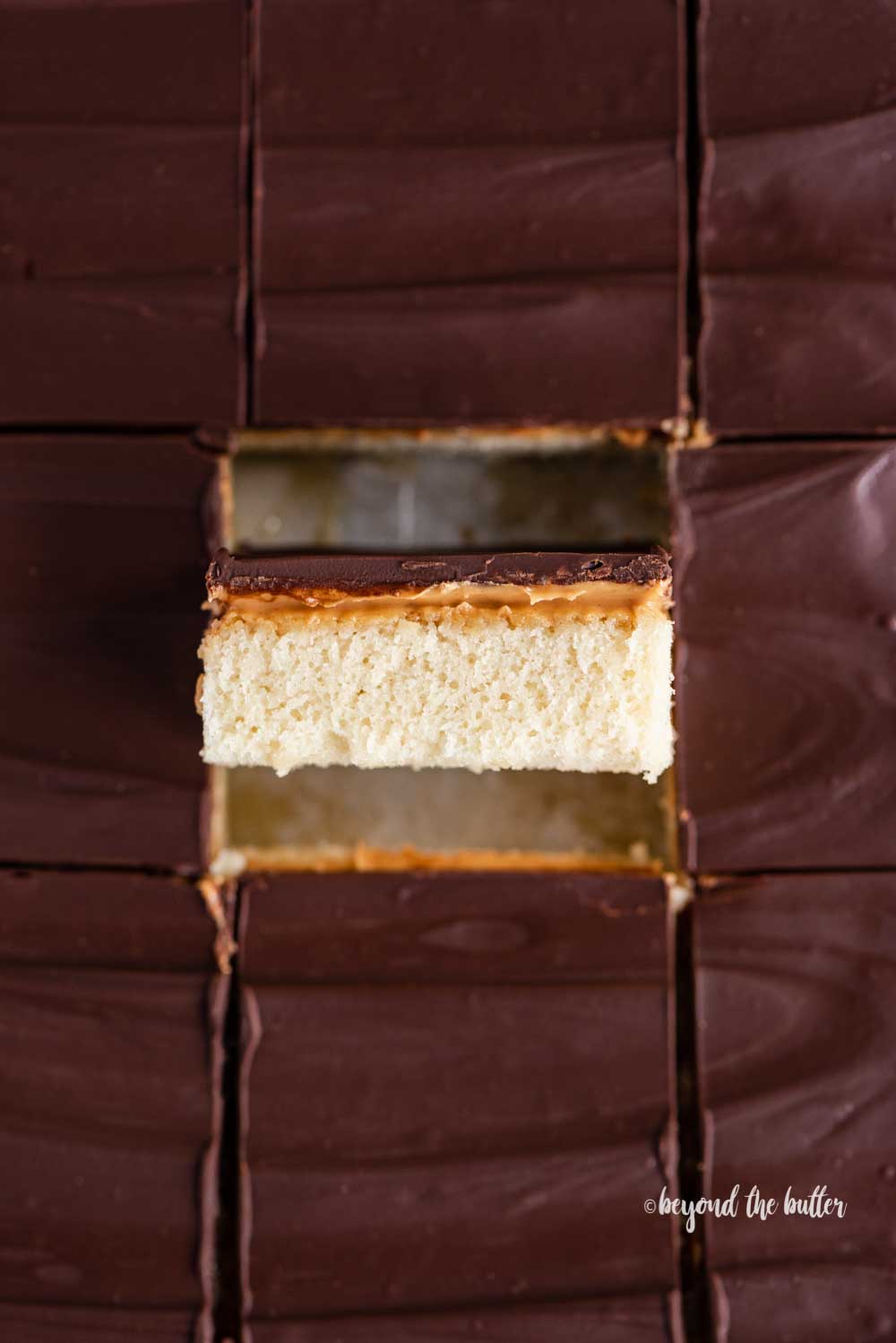 Closeup overhead image of cut irresistible peanut butter tandy kakes with one showing the side view | All Images © Luyiz™