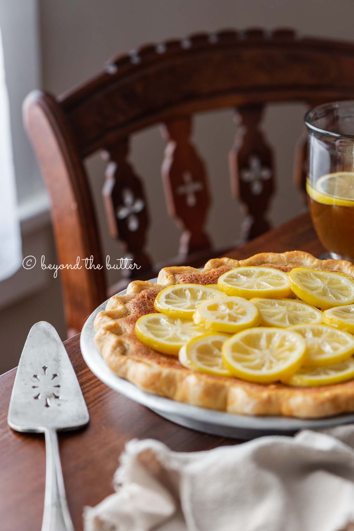 lemon sponge pie on a dark wood dining room table with hot lemon tea | All images © Luyiz®