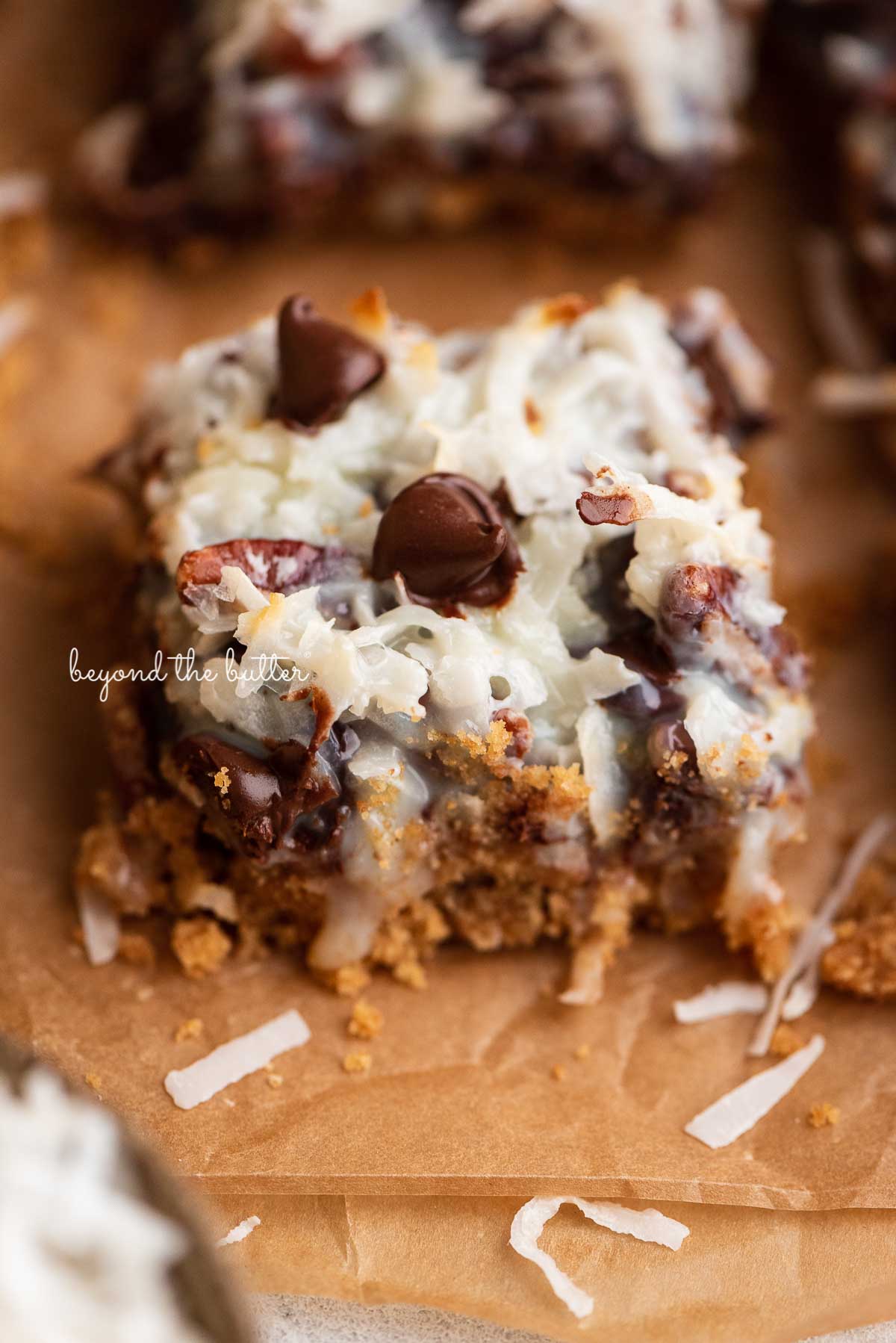 Sliced magic cookie bars on brown parchment paper | © Luyiz®