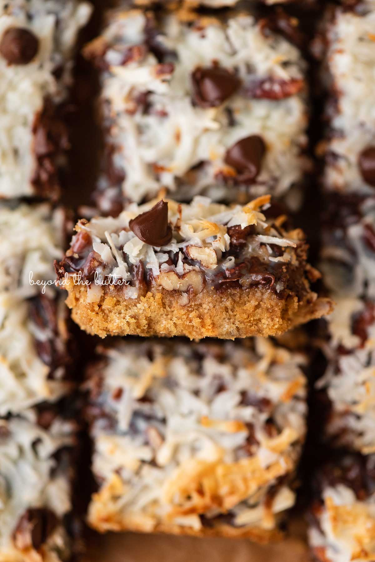 Sliced 7 layer magic cookie bars with center bar on its side | © Luyiz®