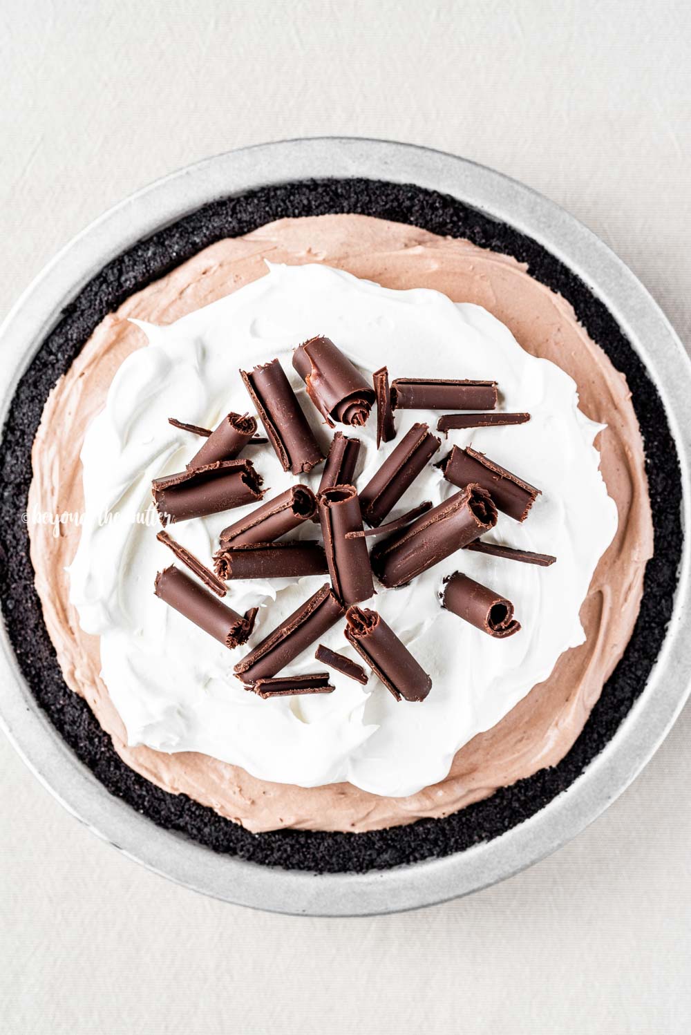 Overhead image of No-Bake Chocolate Cream Pie garnished with Cool Whip and chocolate curls | All Images © Luyiz™
