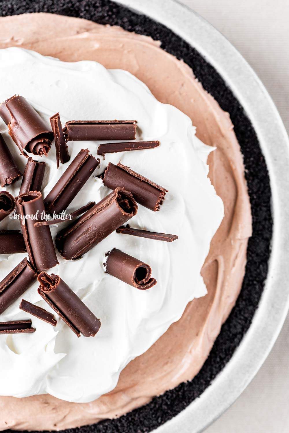 Overhead image of No-Bake Chocolate Cream Pie garnished with Cool Whip and chocolate curls | All Images © Luyiz™