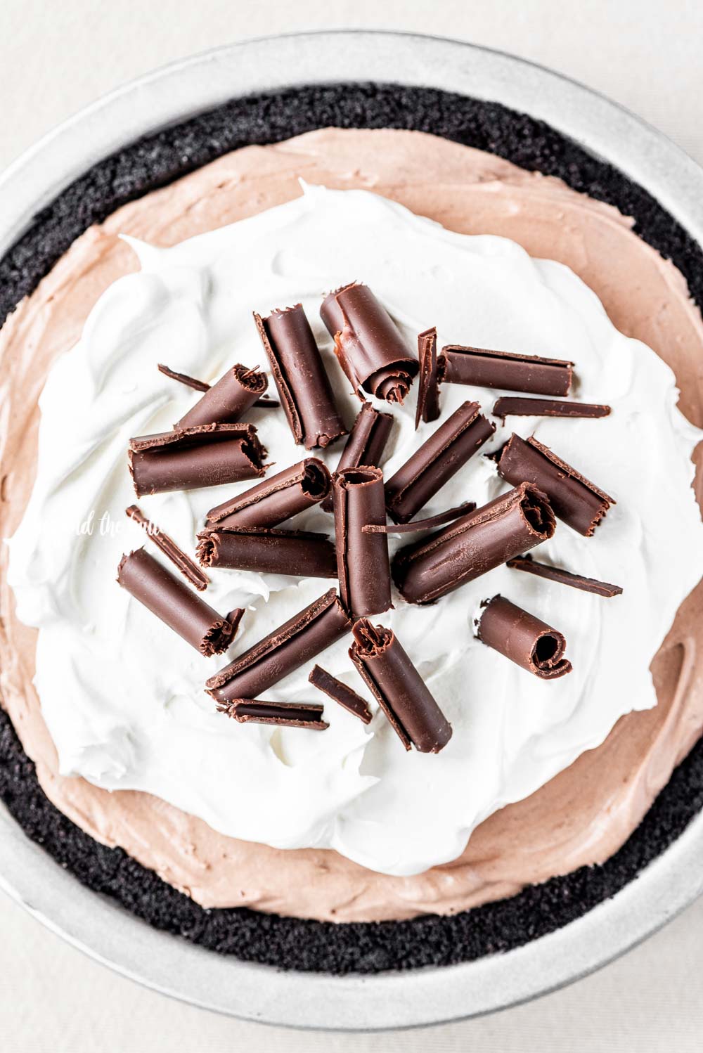 Overhead image of No-Bake Chocolate Cream Pie garnished with Cool Whip and chocolate curls | All Images © Luyiz™