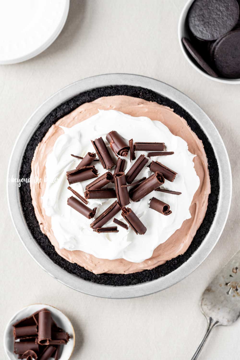 Overhead image of No-Bake Chocolate Cream Pie garnished with Cool Whip and chocolate curls | All Images © Luyiz™