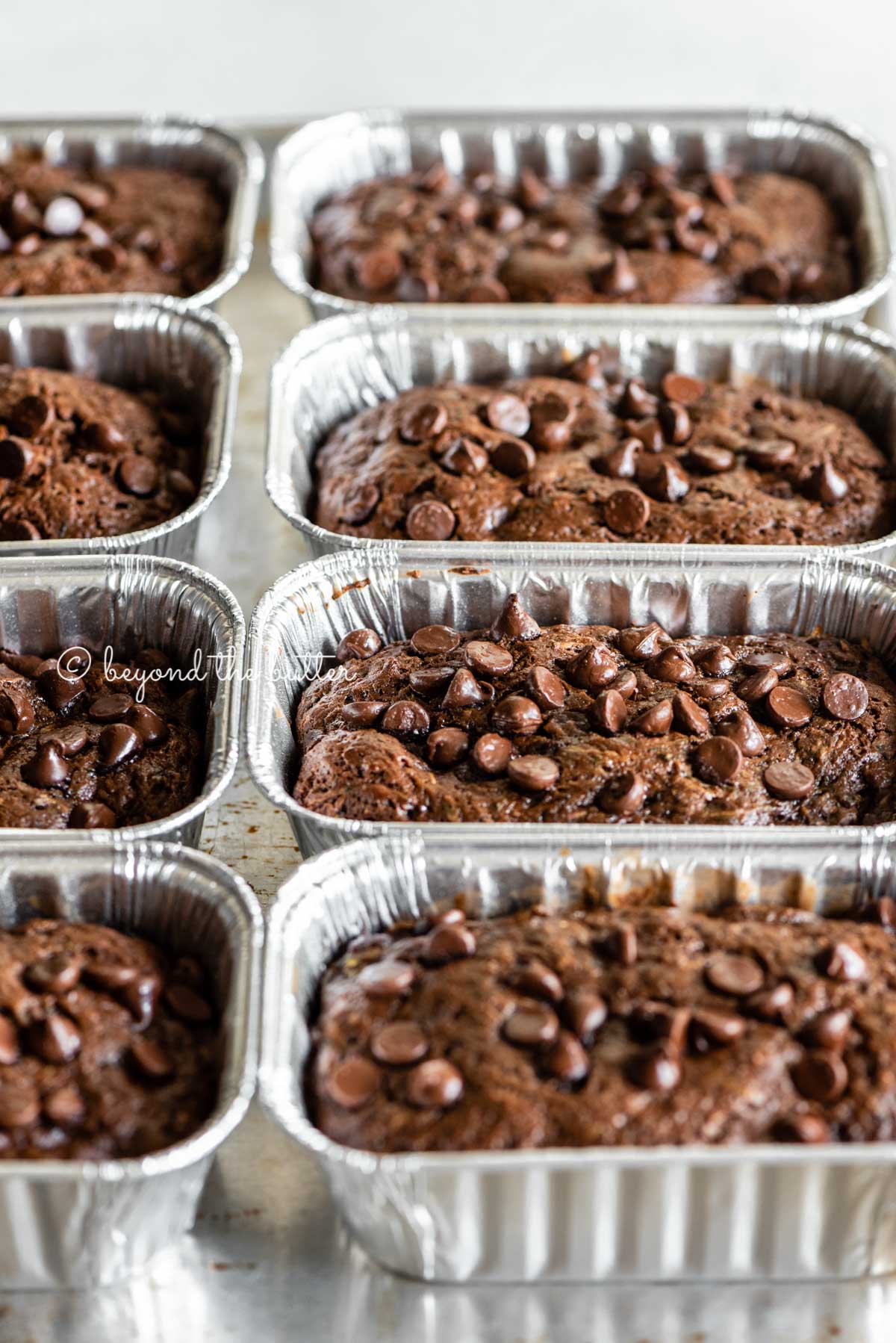 Angled image of mini chocolate zucchini bread loaves | All Images © Luyiz™