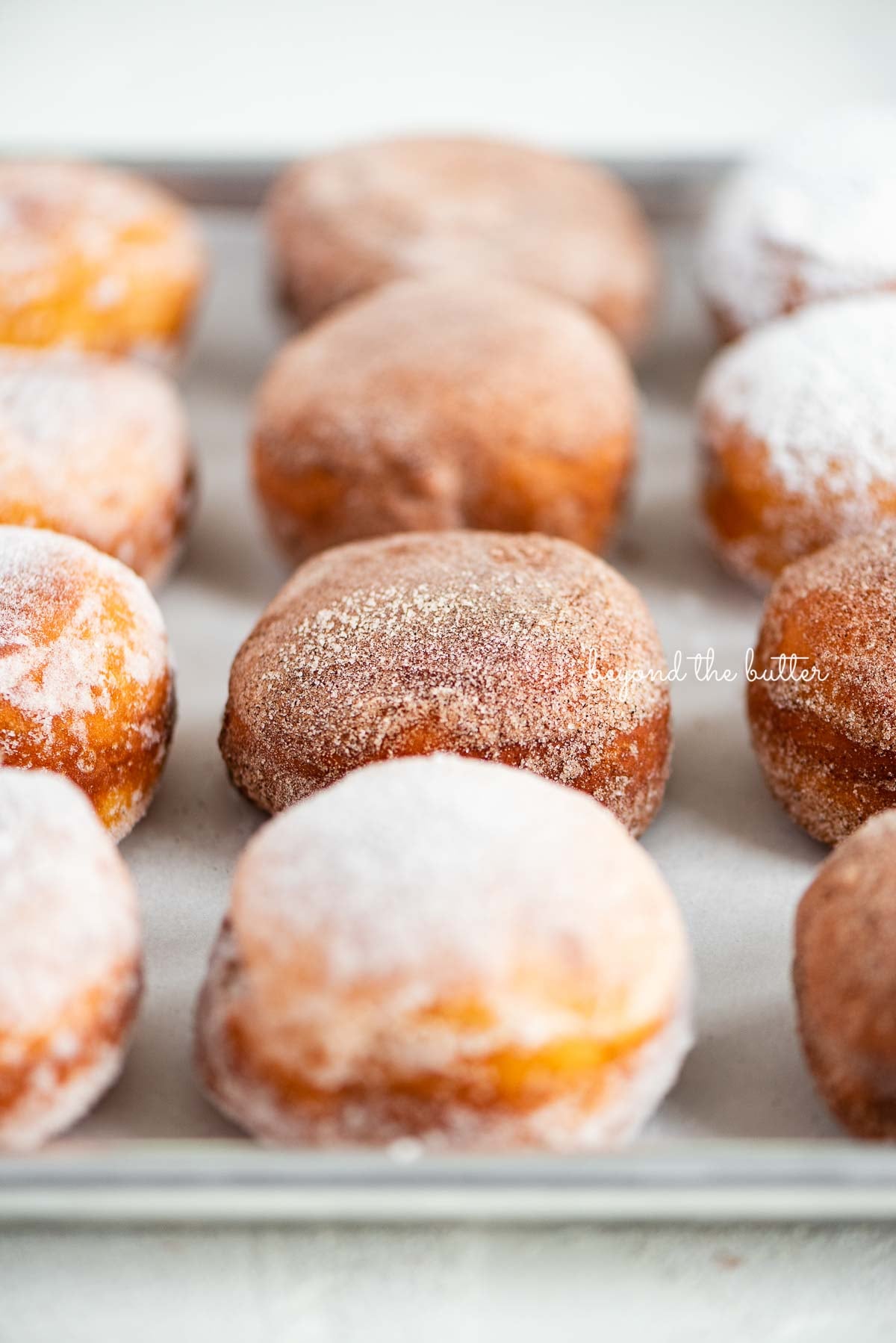 Fasnacht doughnuts on a parchment paper lined baking sheet | © Luyiz®