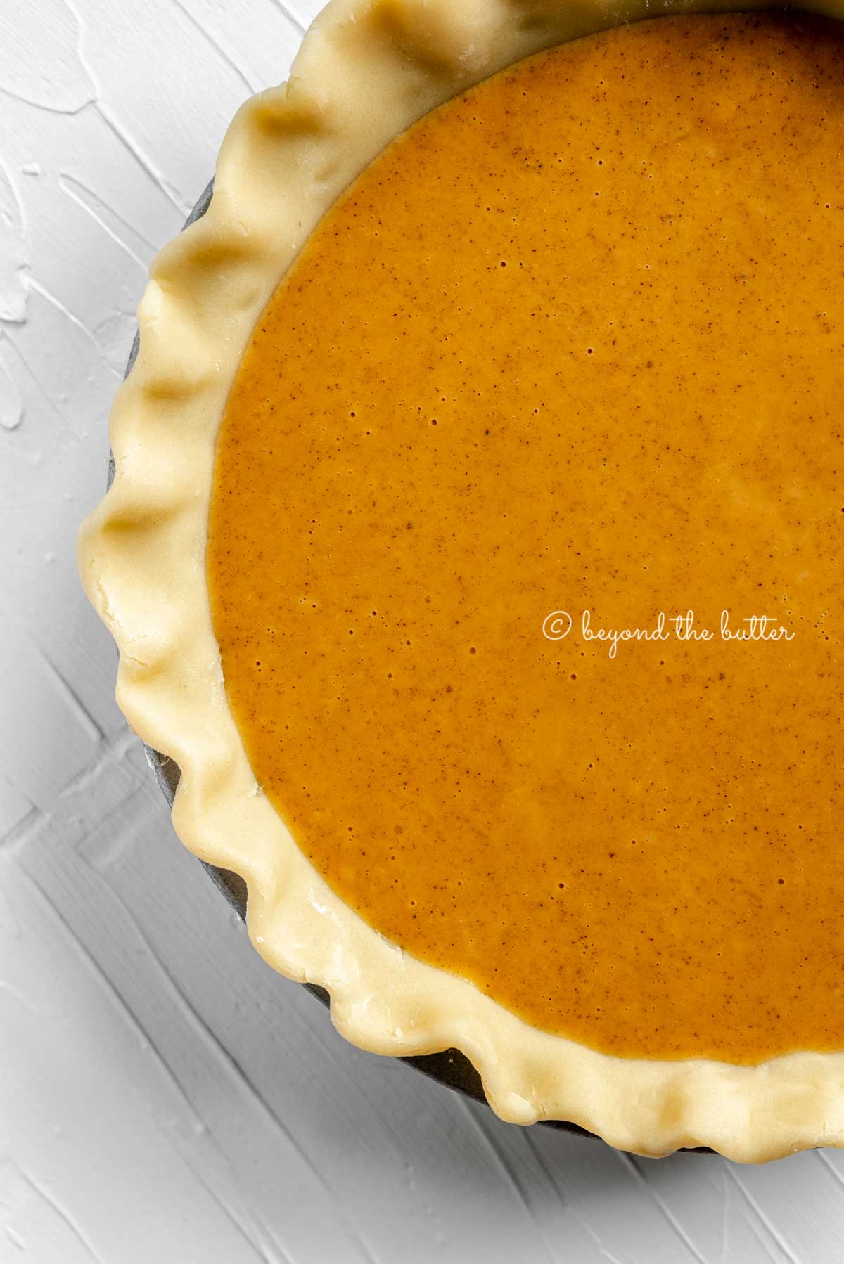 Unbaked pumpkin pie ready for the oven | All Images © Luyiz™