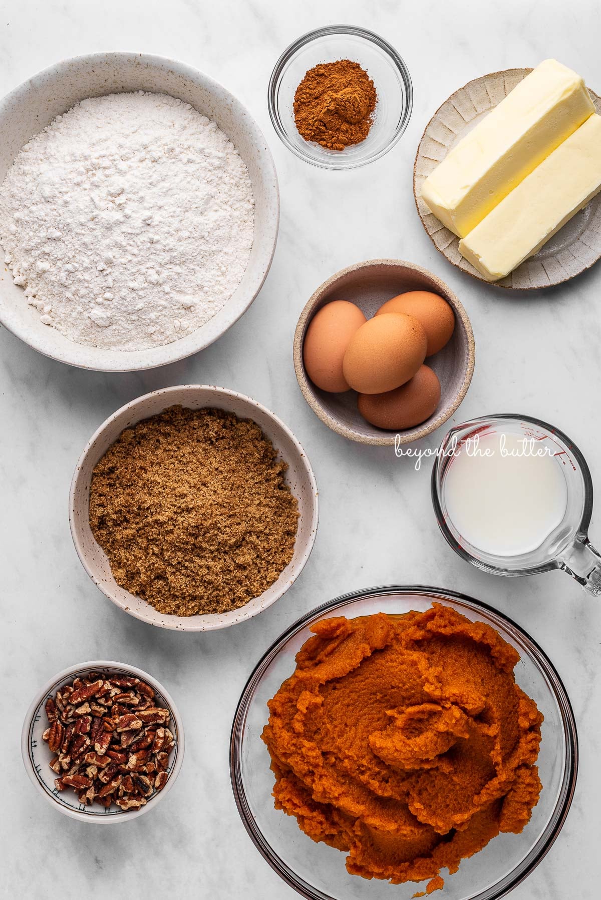 Ingredients of pumpkin pie cake bars on white marbled background | © Luyiz®