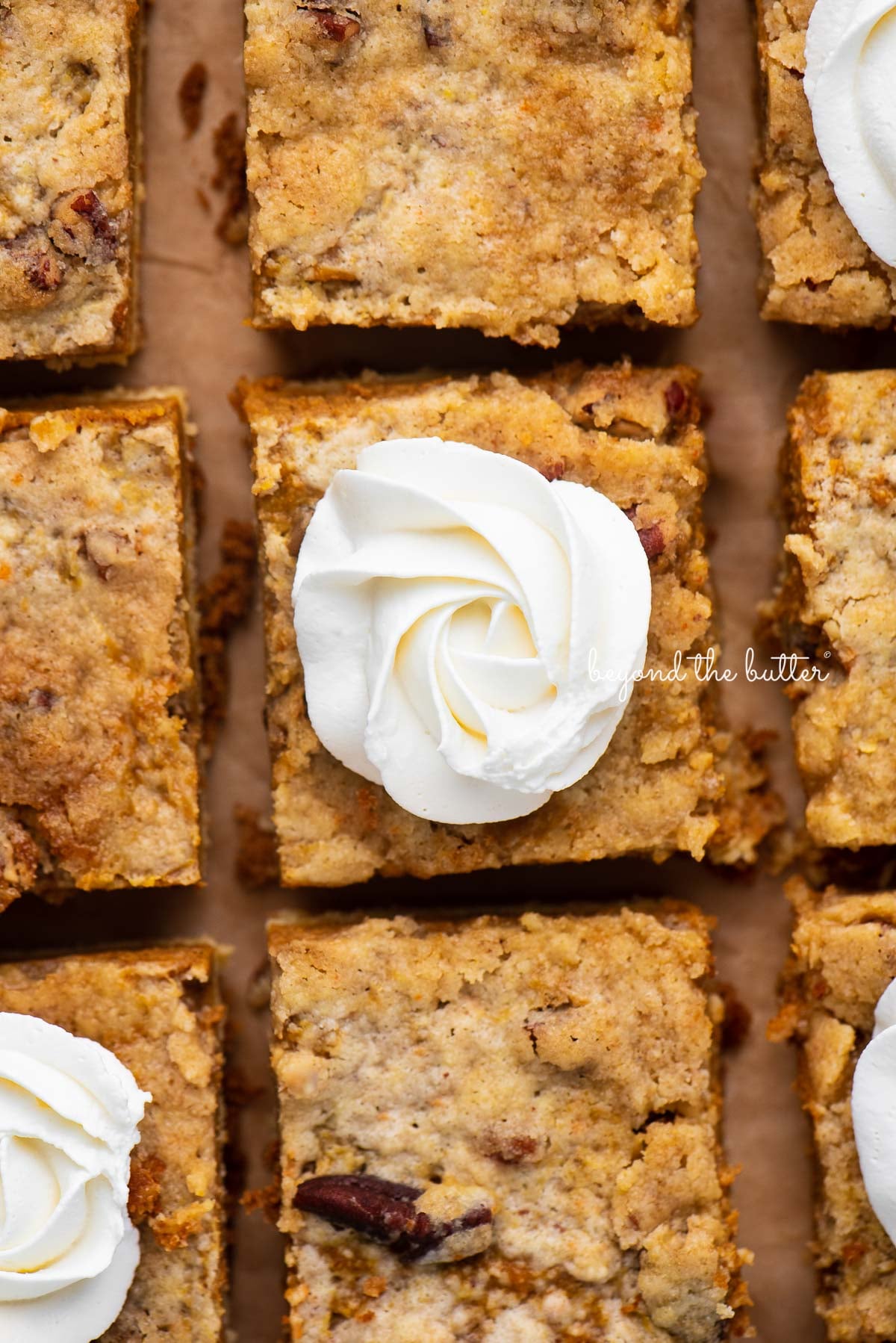 Sliced pumpkin pie cake bars on parchment paper background | © Luyiz®