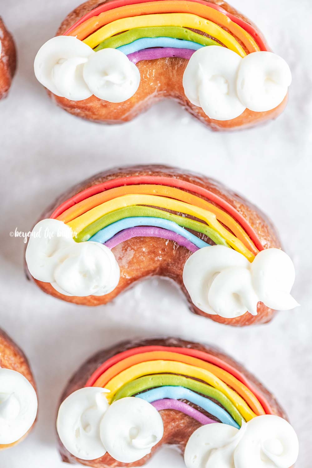 Overhead closeup image of homemade Rainbow Donuts | All Images © Luyiz, LLC