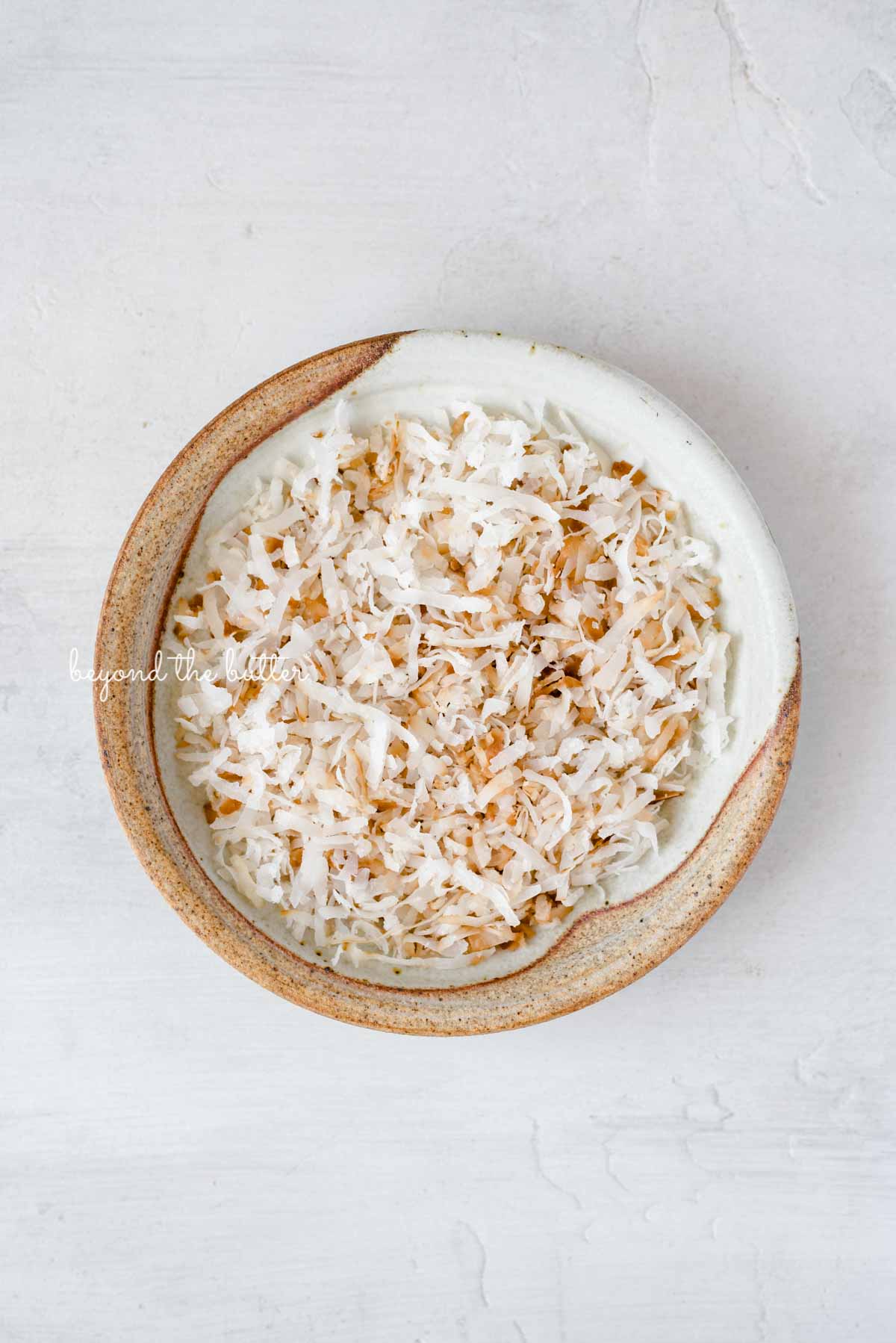Toasted coconut flakes used as a delicious enter in this Robin's Egg Macarons recipe | All images © Luyiz®