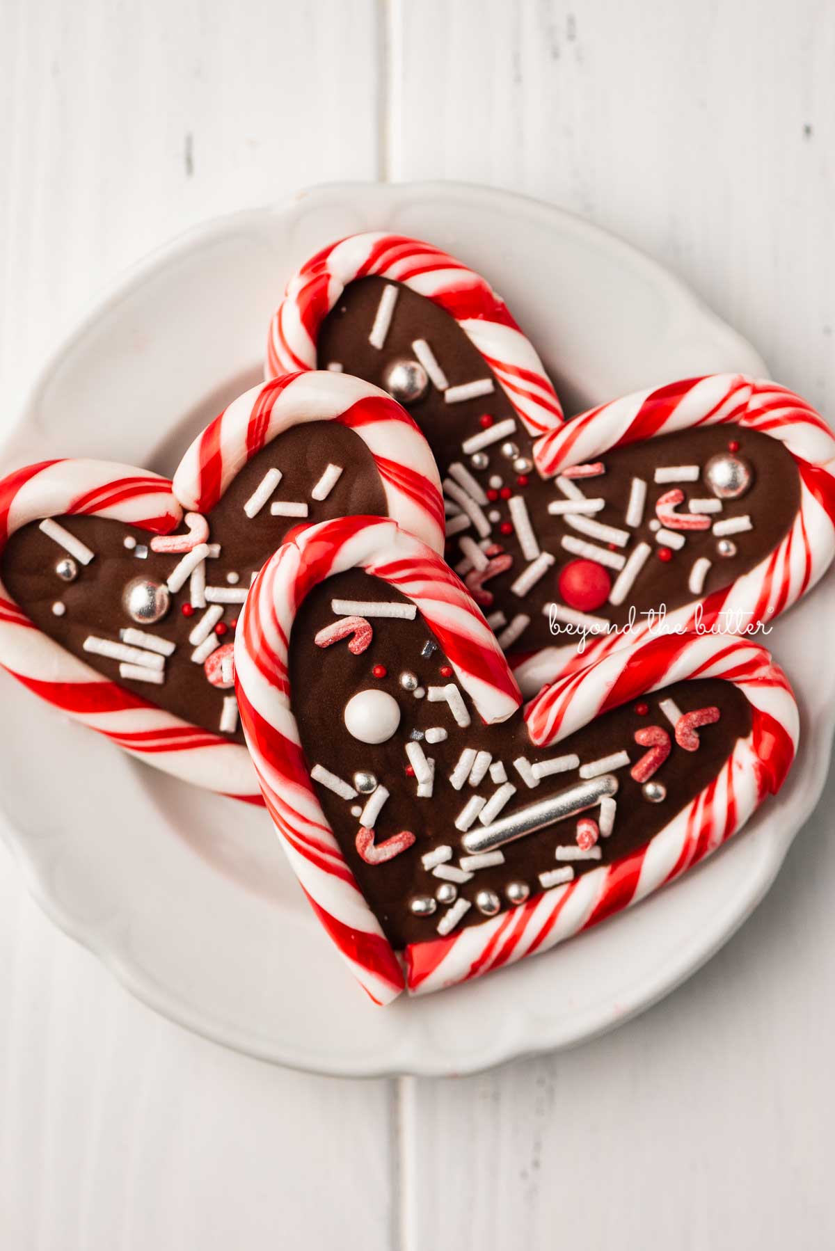 Close up of candy cane hearts on dessert plate | © Luyiz®