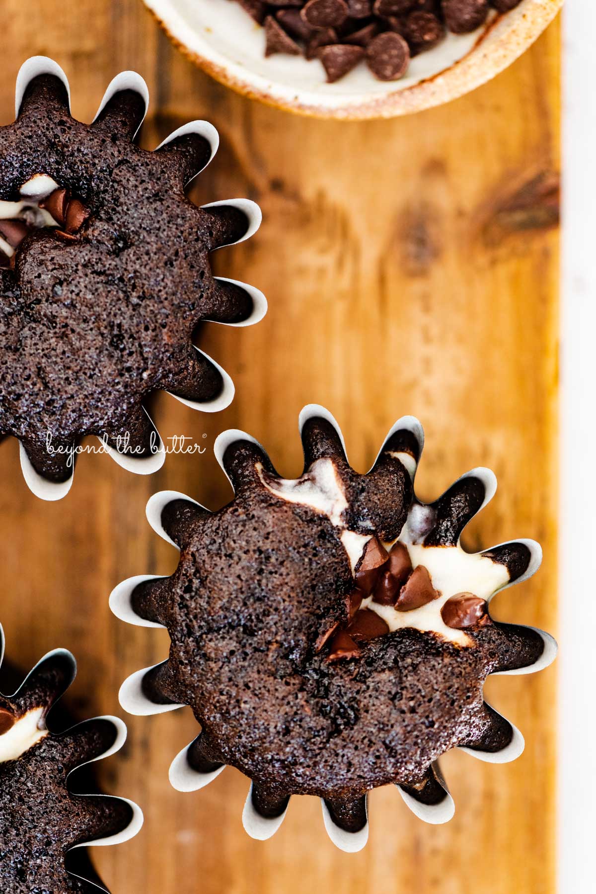 Small batch black bottom cupcakes on a wood cutting board | © Luyiz®