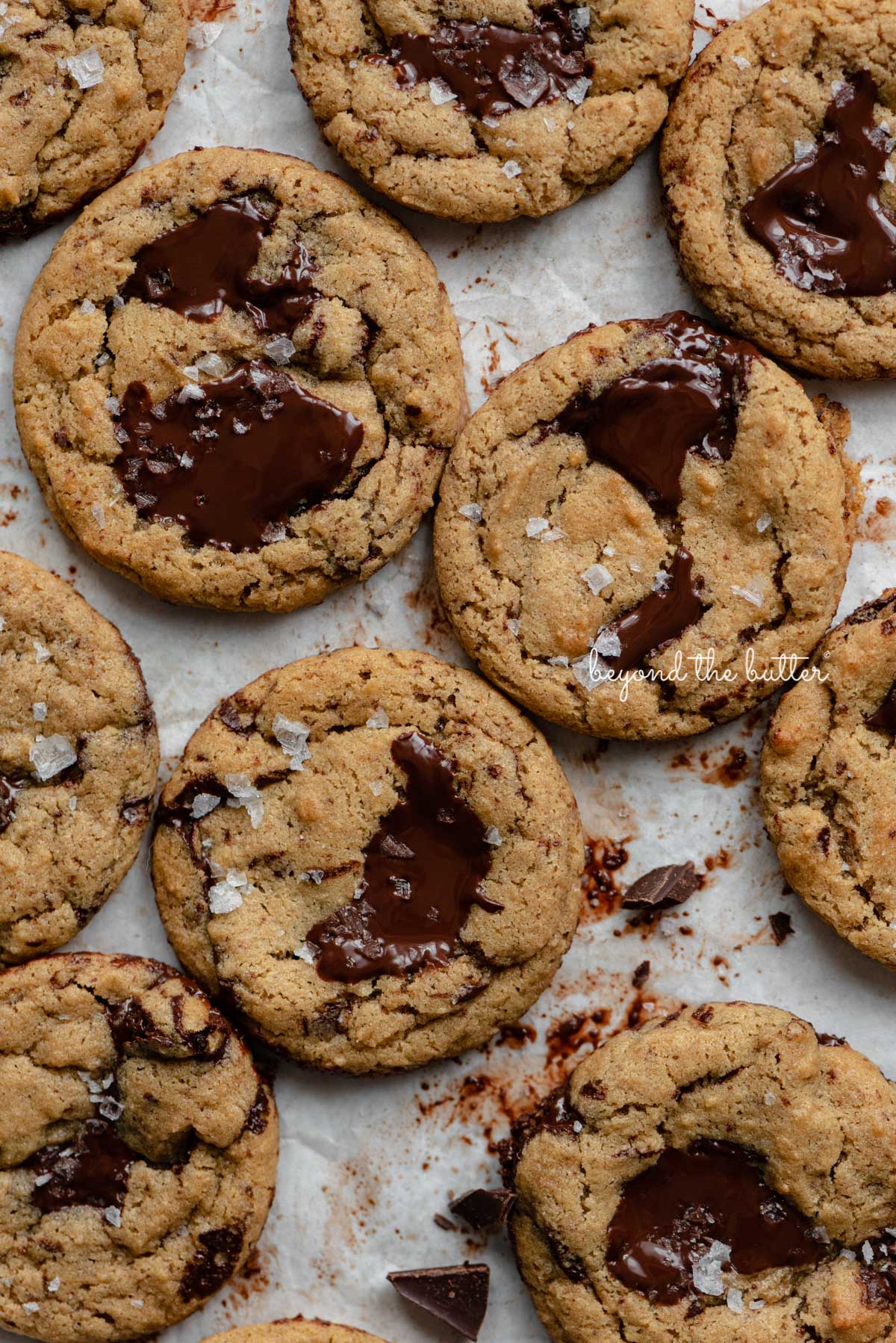 Small batch gluten-free peanut butter chocolate chunk cookies on a parchment paper lined baking sheet | © Luyiz®