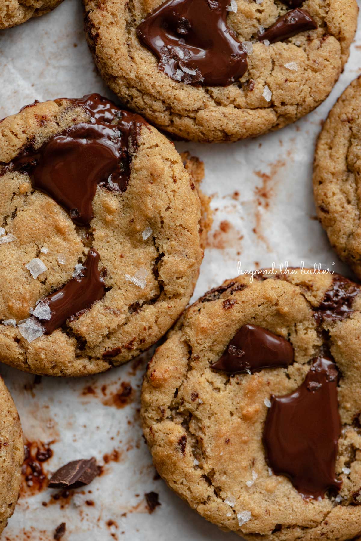 Small batch gluten-free peanut butter chocolate chunk cookies on a parchment paper lined baking sheet | © Luyiz®