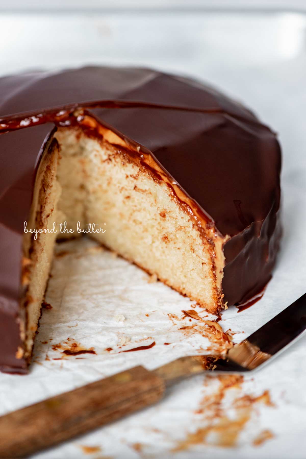 Sliced chocolate peanut butter tandy kake on a parchment paper lined baking sheet | © Luyiz®