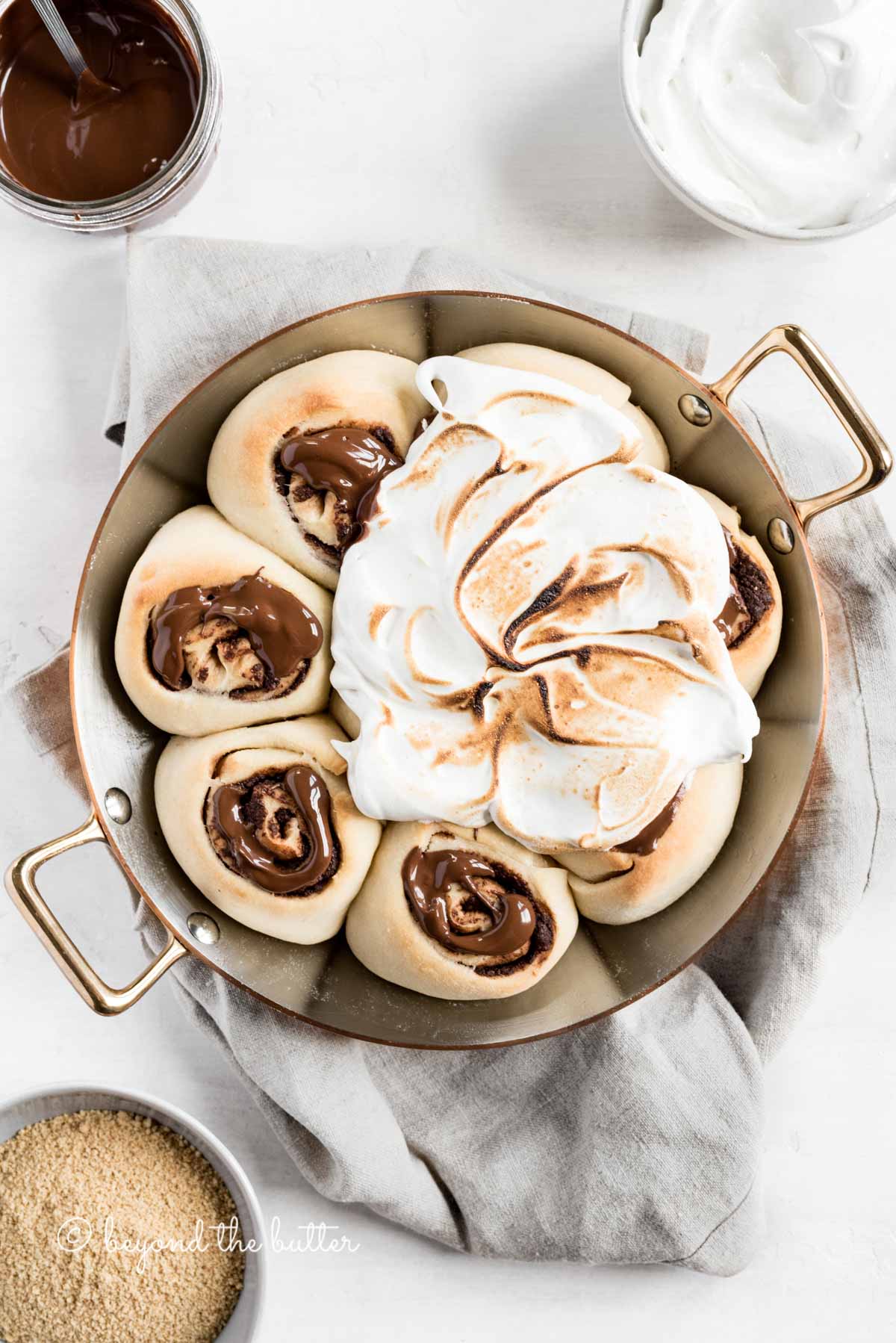 Overhead image of s'mores rolls partially covered with marshmallow topping | All Images © Luyiz™