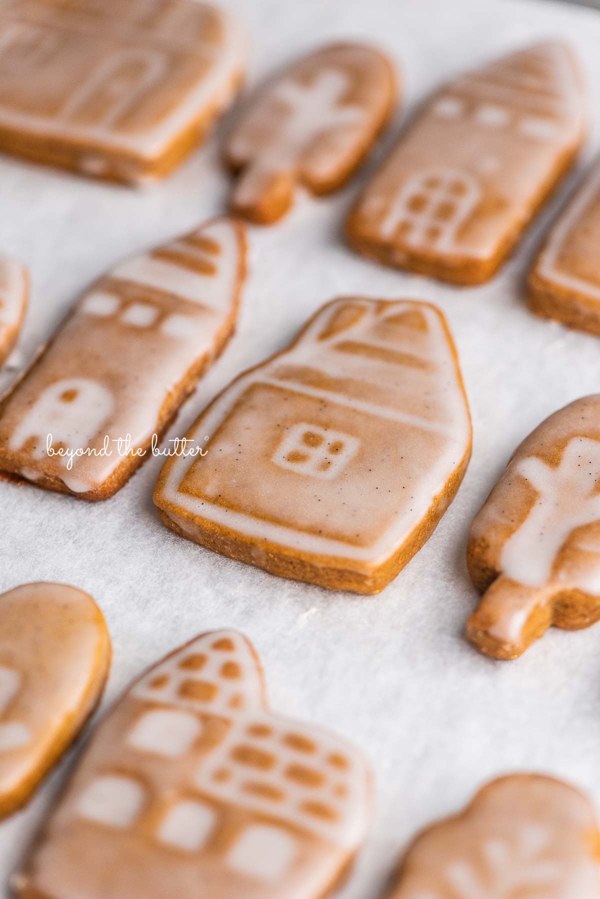 Soft and chewy gingerbread cookies lined up in rows on a white marbled background | © Luyiz, LLC®