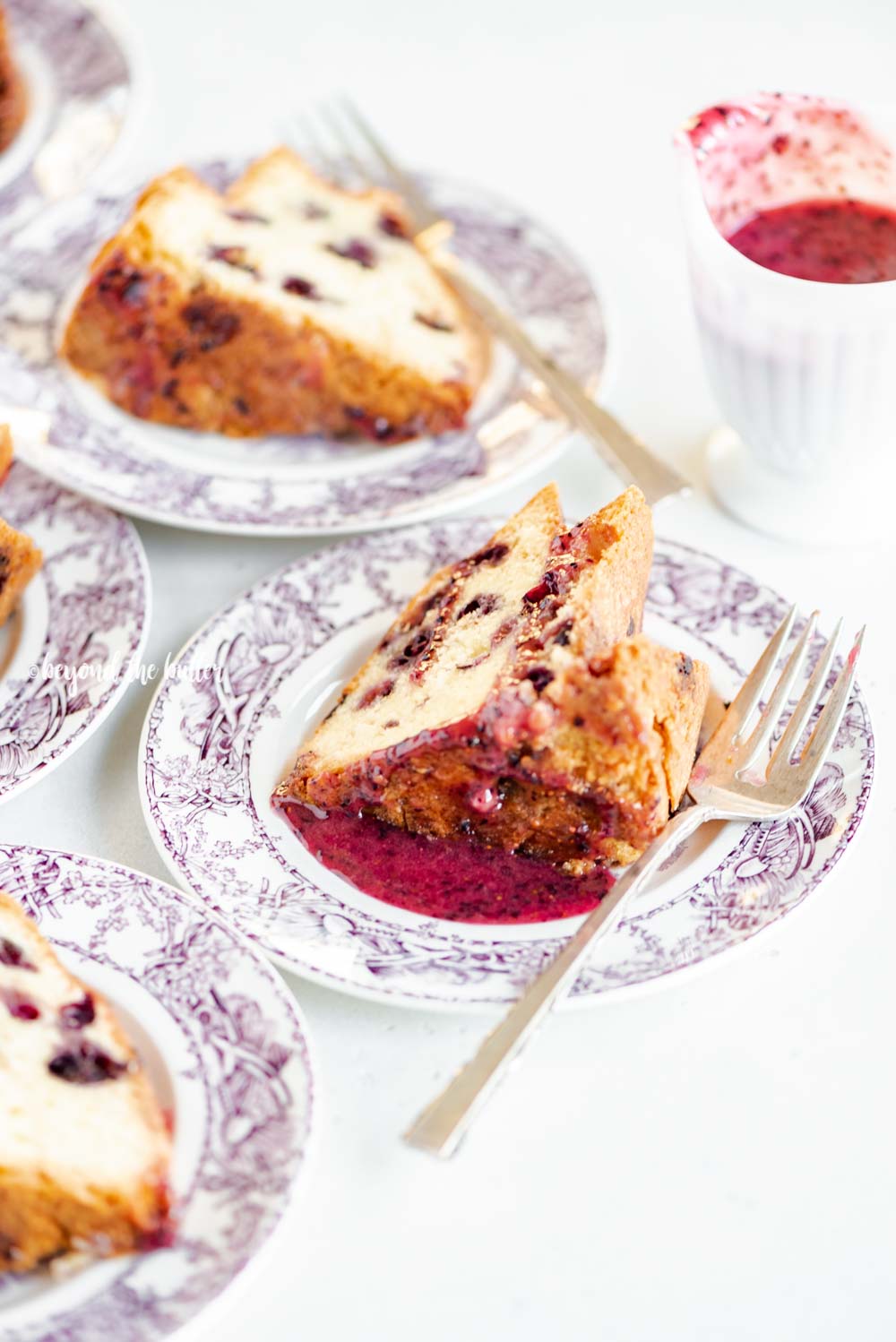 Slices of blueberry bundt cake with blueberry glaze drizzled over the top | All Images © Luyiz, LLC