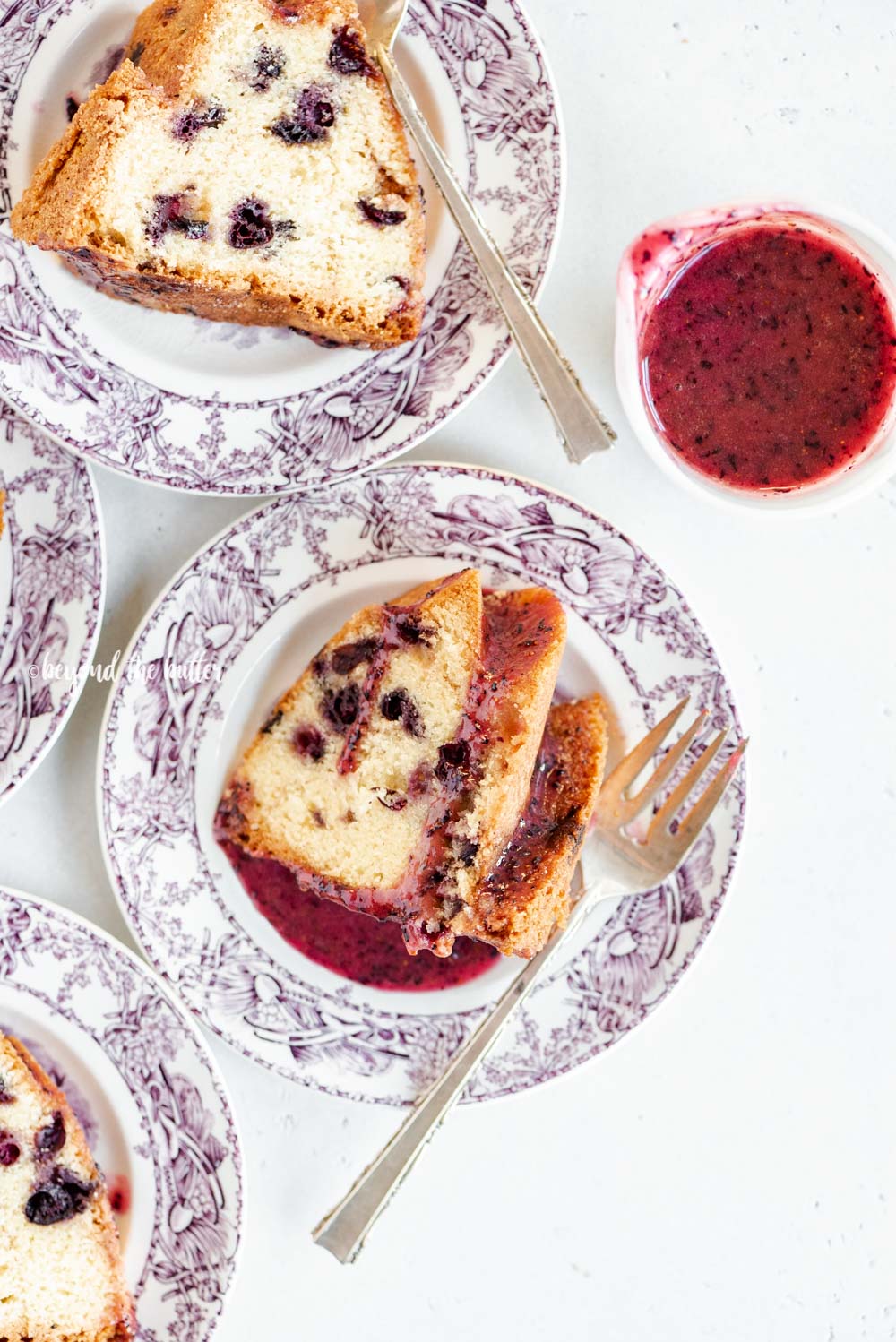 Slices of blueberry bundt cake with blueberry glaze drizzled over the top | All Images © Luyiz, LLC