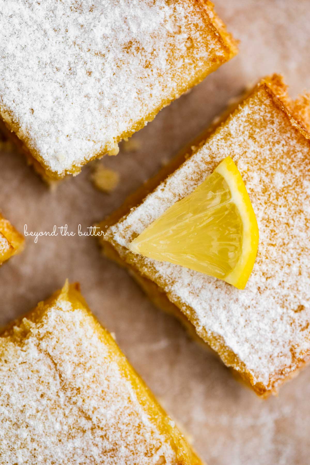 Tart and tangy lemon bars on parchment paper | © Luyiz®