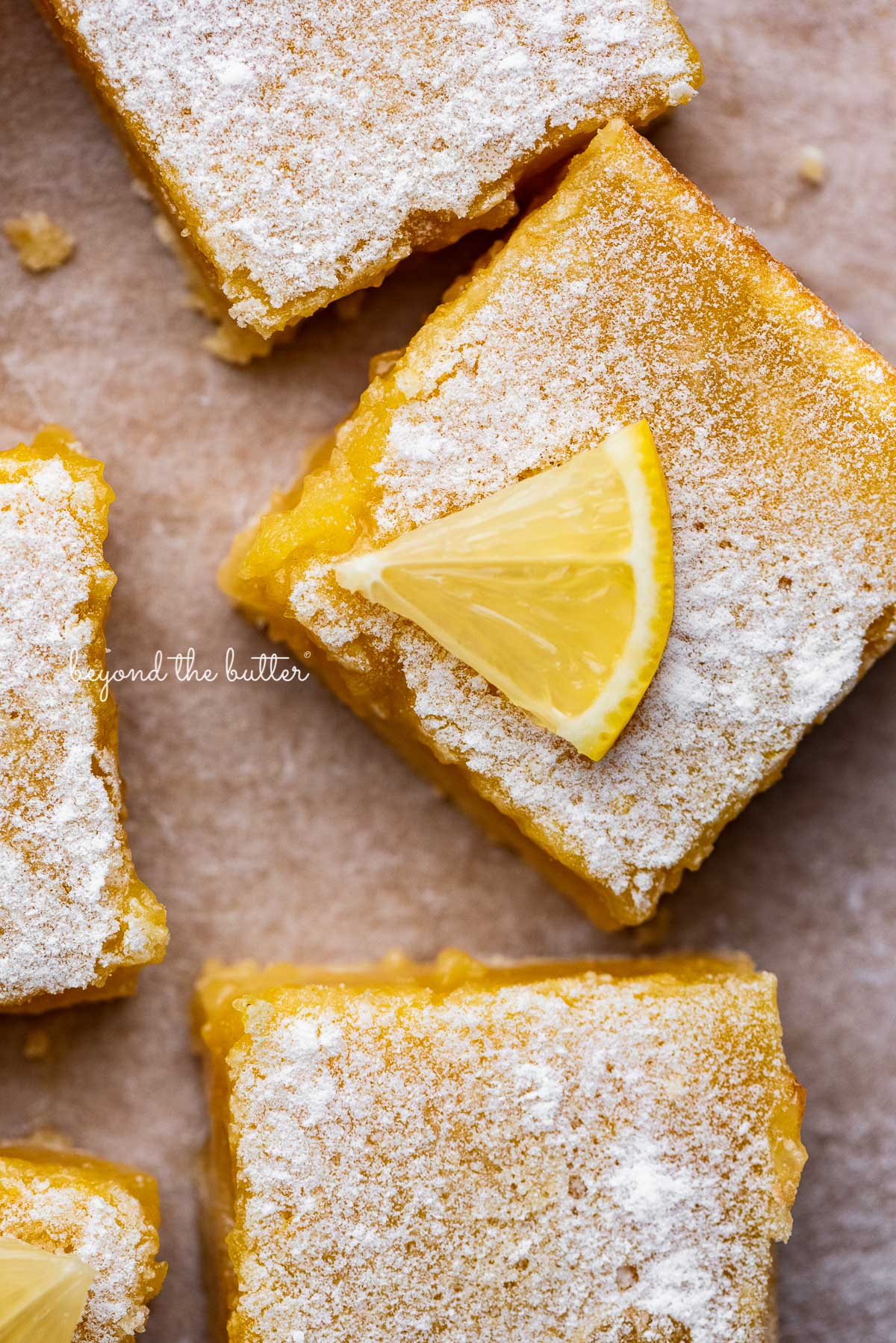 Tart and tangy lemon bars on parchment paper | © Luyiz®