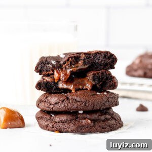 Stack of dark chocolate caramel cookies, with top cookie broken in half