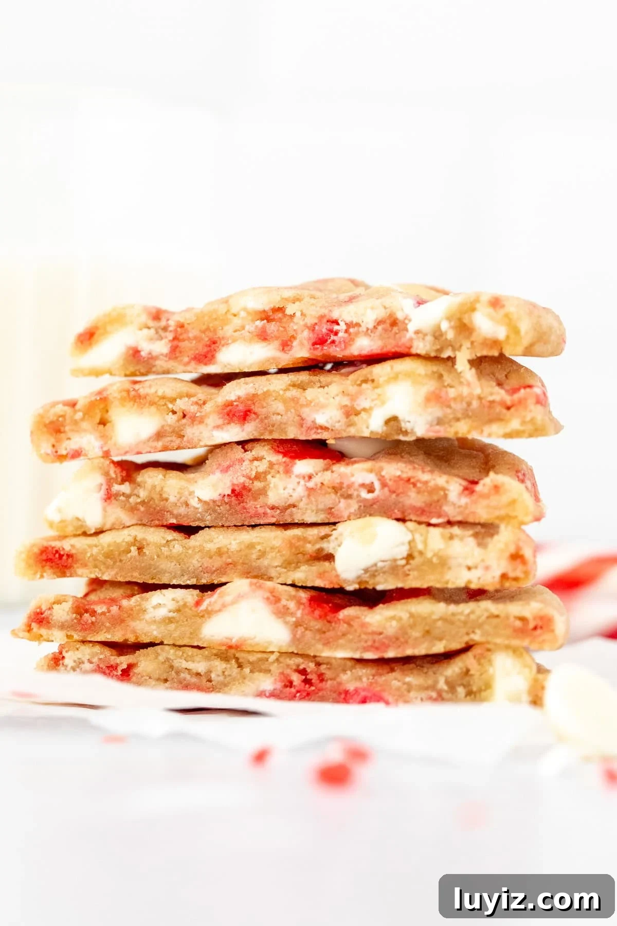 White Chocolate Candy Cane Cookies Recipe for Holiday Baking 6 Candy cane white chocolate chip cookies, cut in half and stacked one on top of another.