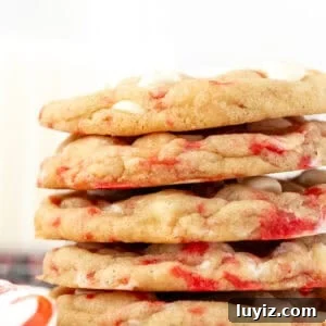 White Chocolate Candy Cane Cookies Recipe for Holiday Baking 7 Peppermint white chocolate chip cookies, stacked on top of another