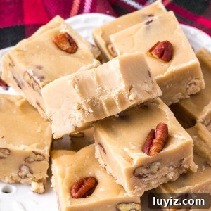 A plate of homemade butter pecan fudge that's sweet, buttery & perfect for the holidays.