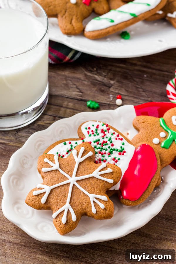 Soft Gingerbread Cookies Recipe: Chewy Spiced Holiday Cookies 3 A plate of soft gingerbread cookies decorated with royal icing - learn all the tricks for making the best gingerbread.